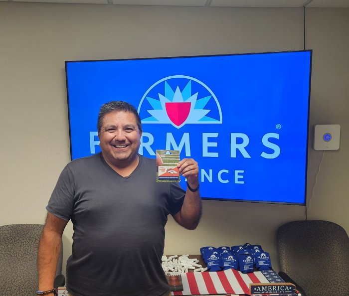 A customer winning a gift card at the Reardon Agency office